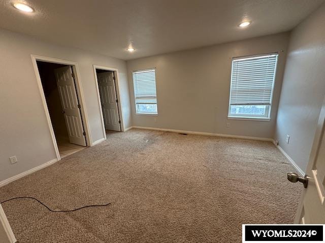 unfurnished bedroom with light carpet