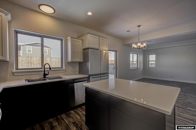 kitchen with plenty of natural light, dark hardwood / wood-style flooring, sink, and stainless steel appliances