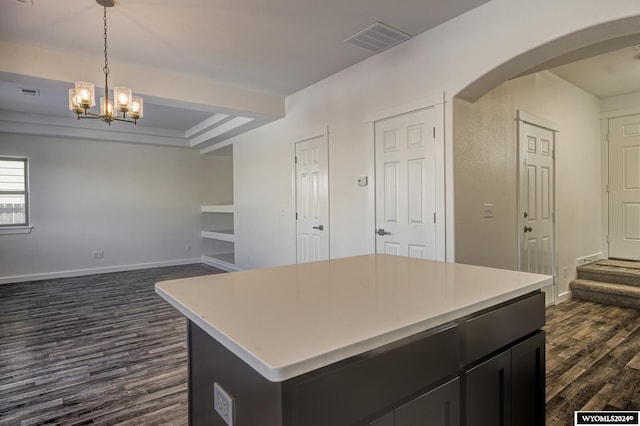 kitchen featuring dark hardwood / wood-style flooring, hanging light fixtures, and a center island