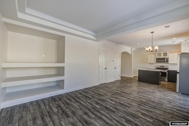 unfurnished living room with dark wood-type flooring and built in shelves