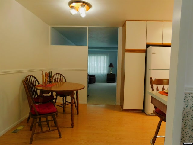 dining space featuring light hardwood / wood-style floors