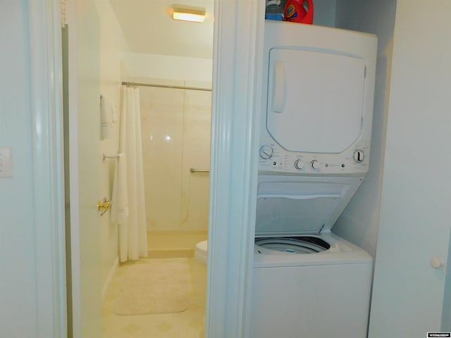 laundry area with stacked washing maching and dryer