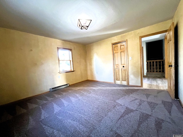 carpeted empty room with a baseboard radiator