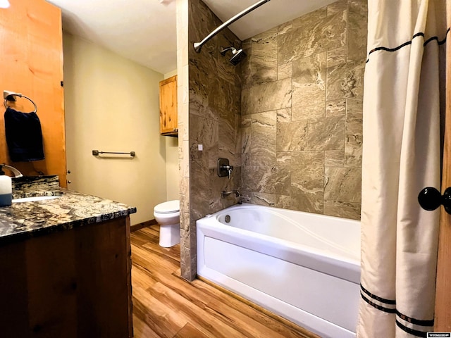 full bathroom with hardwood / wood-style floors, vanity, toilet, and shower / tub combo with curtain