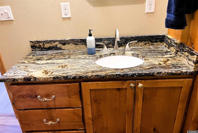 bathroom with vanity and hardwood / wood-style flooring