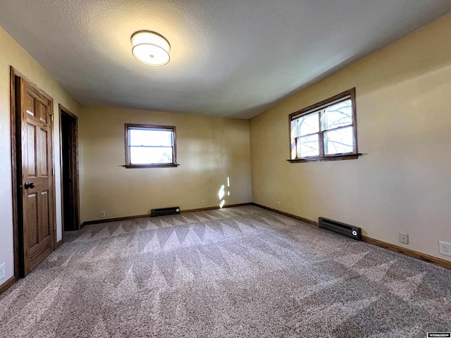 spare room featuring carpet and a textured ceiling