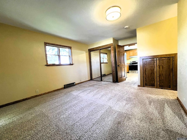 unfurnished bedroom featuring carpet flooring and a closet