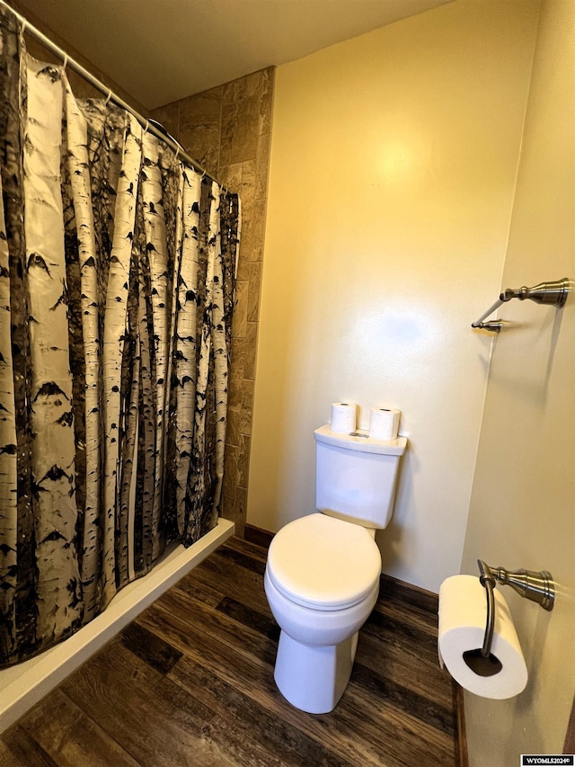 bathroom with walk in shower, hardwood / wood-style flooring, and toilet