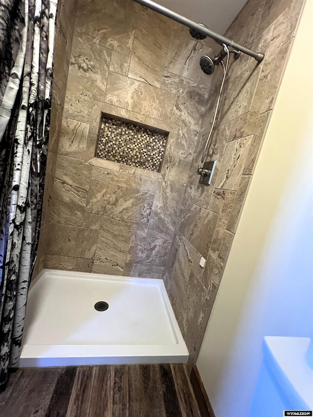 bathroom with hardwood / wood-style floors and curtained shower