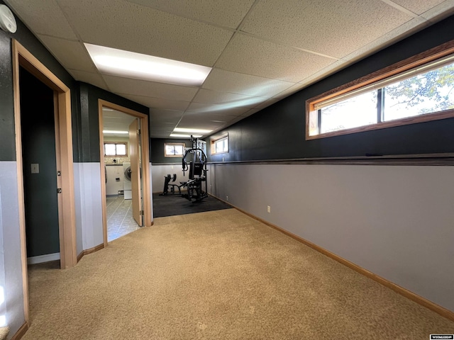 basement with a drop ceiling and carpet floors