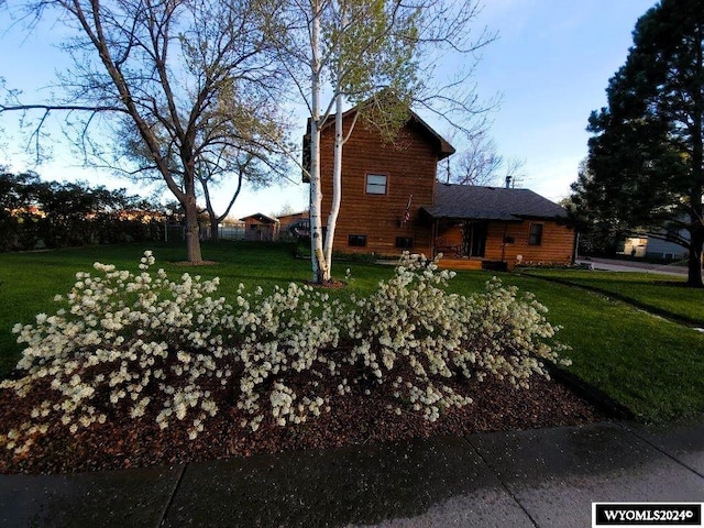 view of home's exterior with a yard