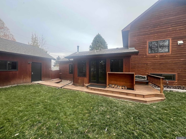 rear view of property with a yard and a wooden deck