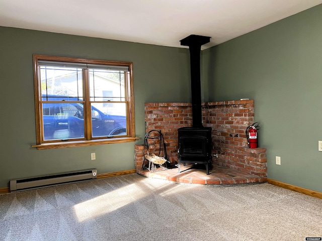 unfurnished living room featuring carpet, a wood stove, and baseboard heating