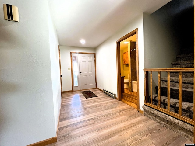 hall featuring baseboard heating and light hardwood / wood-style floors