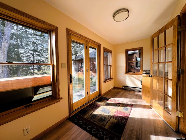 doorway with french doors, dark hardwood / wood-style floors, and a baseboard radiator