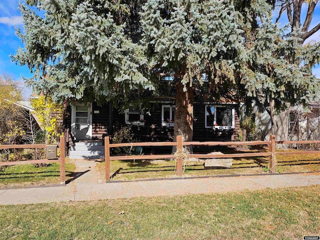 obstructed view of property featuring a front yard