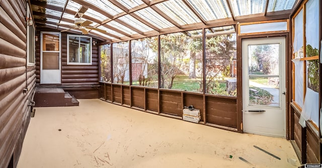 unfurnished sunroom with ceiling fan