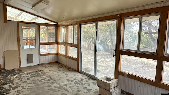 unfurnished sunroom featuring vaulted ceiling