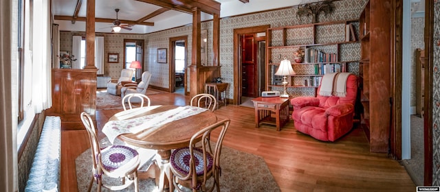 dining room with ceiling fan, hardwood / wood-style floors, ornate columns, and beam ceiling