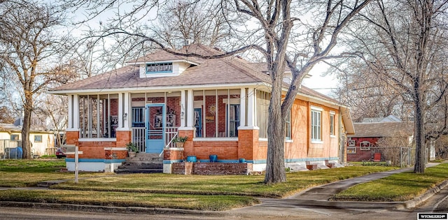 bungalow-style house with a porch and a front lawn