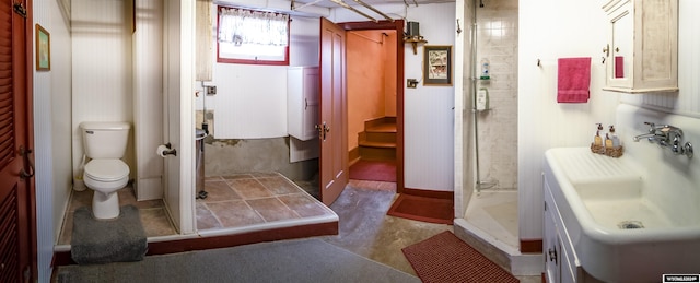 bathroom featuring sink, toilet, and a shower