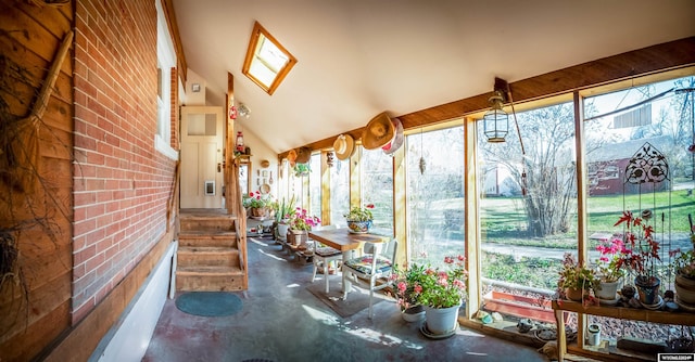 sunroom featuring vaulted ceiling