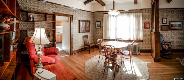 dining area with hardwood / wood-style floors and beam ceiling