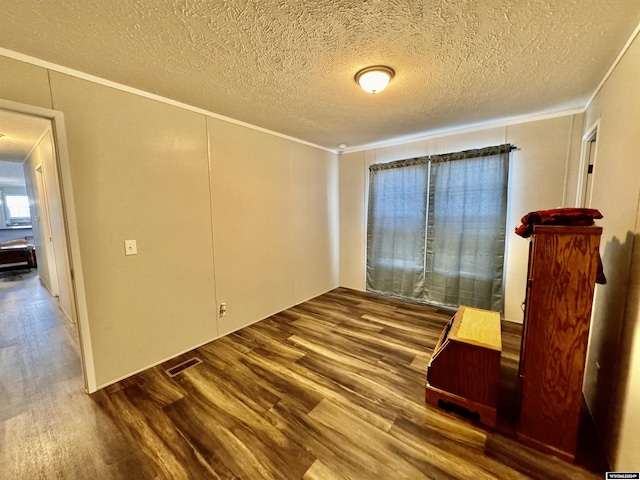 9 Sequoia Dr, Casper, WY 82604 - unfurnished room with wood finished floors, crown molding, and a textured ceiling