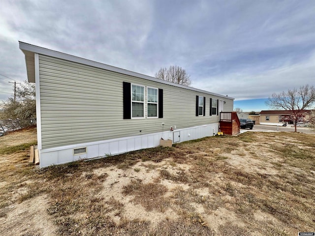 view of property exterior featuring a deck