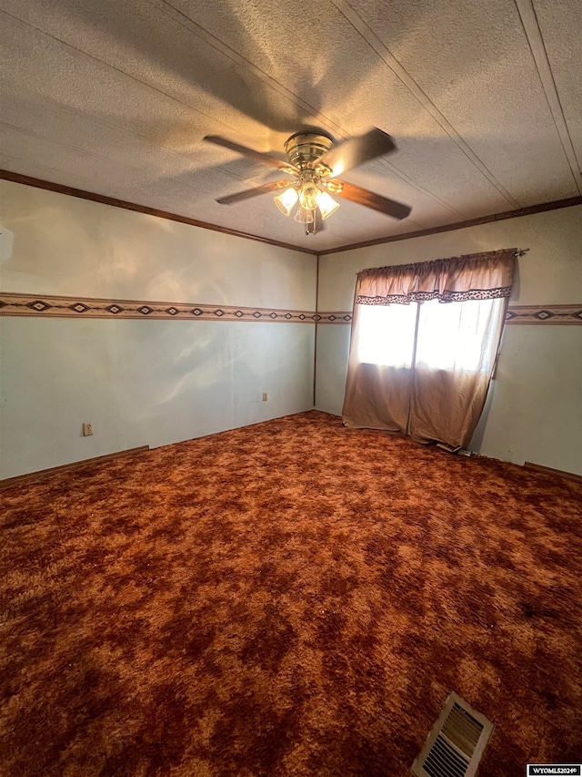 carpeted empty room featuring crown molding, a textured ceiling, and ceiling fan