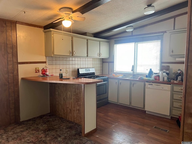 kitchen with lofted ceiling with beams, dark wood-type flooring, range with gas cooktop, dishwasher, and kitchen peninsula