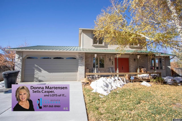 view of front facade featuring a front lawn, a garage, and covered porch