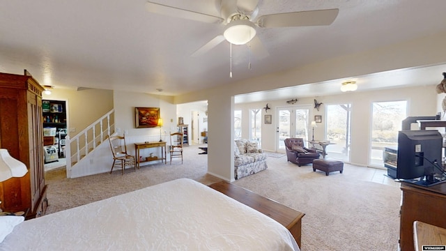 bedroom featuring ceiling fan, light carpet, and access to outside