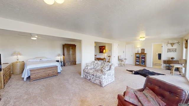 carpeted living room featuring a textured ceiling, ceiling fan, and a baseboard heating unit