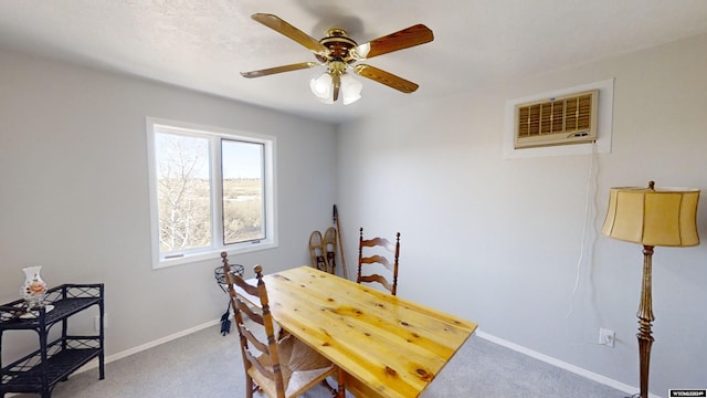 carpeted dining room with a wall unit AC and ceiling fan