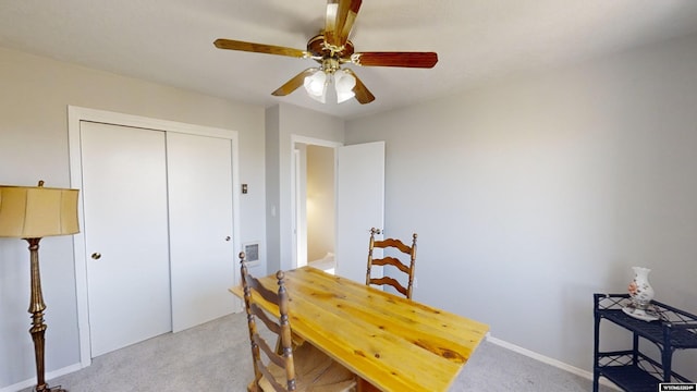 carpeted dining area featuring ceiling fan