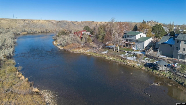 birds eye view of property with a water and mountain view