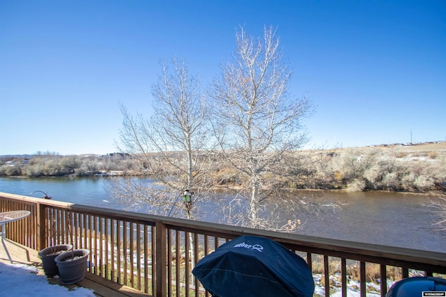 deck with a water view and grilling area