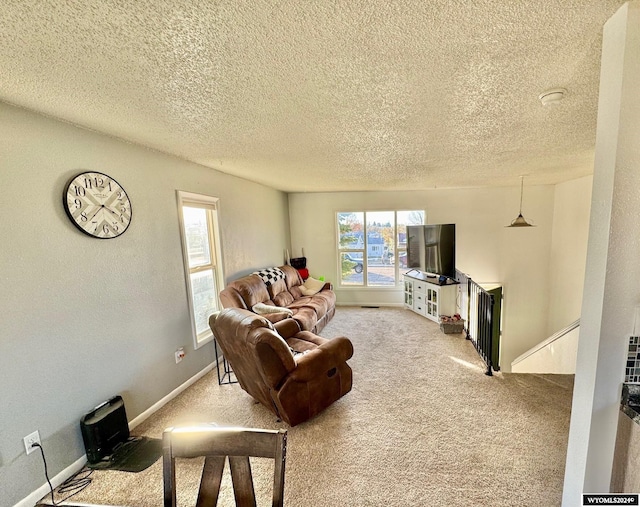 carpeted living room featuring a textured ceiling