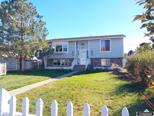 raised ranch featuring a front lawn