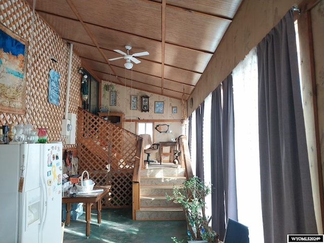 interior space featuring ceiling fan and vaulted ceiling