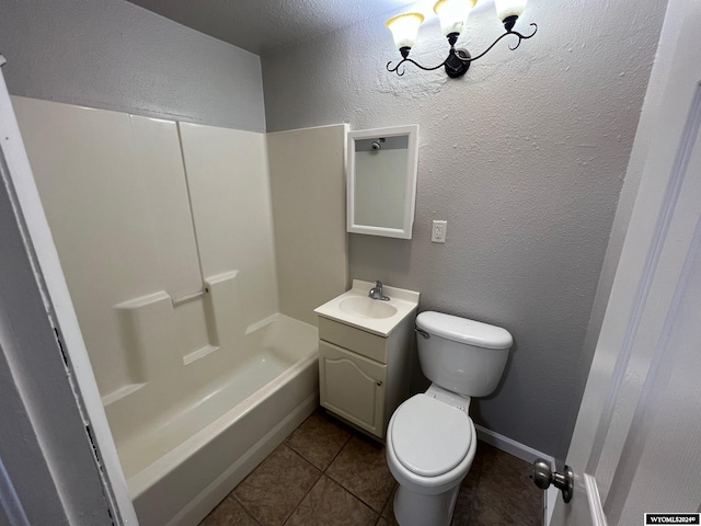 bathroom with toilet, vanity, and tile patterned flooring