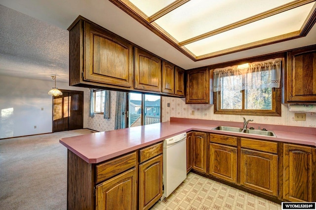 kitchen with a textured ceiling, light carpet, sink, dishwasher, and kitchen peninsula