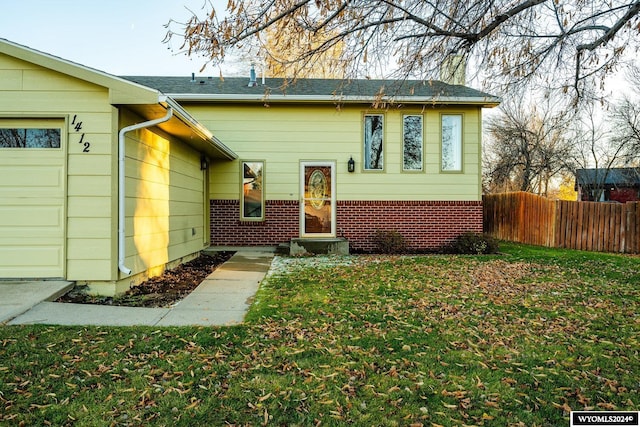 view of front of property featuring a garage and a front lawn