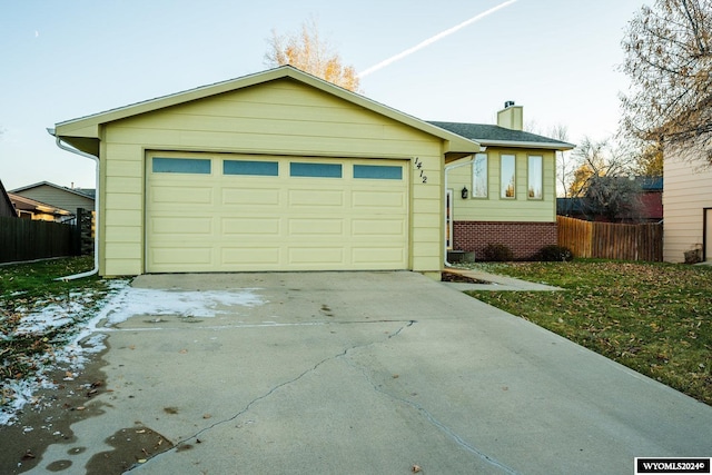 view of front of property with a front lawn and a garage