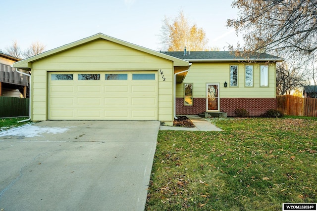 ranch-style home featuring a garage and a front yard