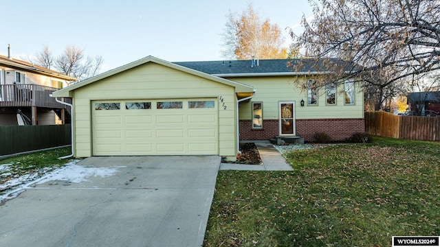 ranch-style home with a front lawn and a garage