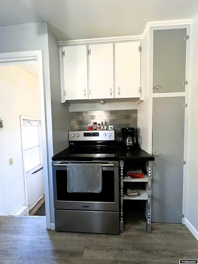 kitchen featuring white cabinets, dark hardwood / wood-style flooring, and stainless steel electric range oven