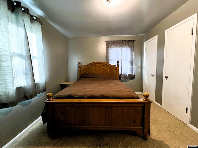 bedroom featuring lofted ceiling and carpet flooring