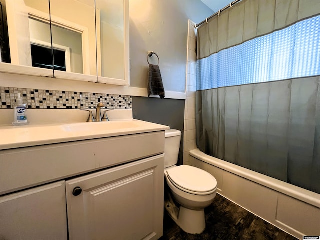 full bathroom featuring toilet, tasteful backsplash, vanity, and shower / bath combination with curtain